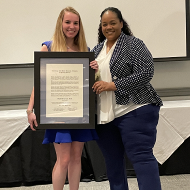 Photo of Meghan Case MD receiving the Bevill Award from Shannon Pittman MD